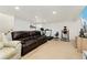 Spacious basement with exercise equipment and a large brown sofa, perfect for a home gym at 1730 Ward Cir, Franktown, CO 80116