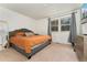 Bright bedroom featuring a queen-sized bed, neutral walls, and a window with natural light at 1730 Ward Cir, Franktown, CO 80116