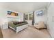 Bright bedroom with a white bed, chair, mounted TV, and a view of the window at 1730 Ward Cir, Franktown, CO 80116