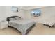 Modern bedroom with a large TV, plush gray bedding, and a sleek, minimalist design at 1730 Ward Cir, Franktown, CO 80116