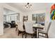 Formal dining area with a table, chairs, and view of the living room and a patio at 1730 Ward Cir, Franktown, CO 80116