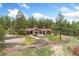 Charming ranch-style home nestled among mature trees with circular driveway at 1730 Ward Cir, Franktown, CO 80116