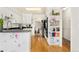Bright kitchen with white cabinetry, black countertops and modern appliances at 1730 Ward Cir, Franktown, CO 80116