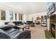 Bright and open living room with a large leather couch, fireplace, and view to dining room at 1730 Ward Cir, Franktown, CO 80116