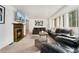 Spacious living room with a fireplace, large windows, and comfortable leather couches at 1730 Ward Cir, Franktown, CO 80116