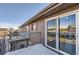View of the balcony with railings, sliding glass door, and brown shingled exterior at 3855 S Monaco St # 209, Denver, CO 80237