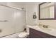 Modern bathroom featuring a sleek vanity, sliding glass shower doors, and updated fixtures at 3855 S Monaco St # 209, Denver, CO 80237