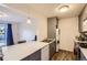 Open kitchen showcasing a peninsula countertop, stainless steel appliances, and wood flooring at 3855 S Monaco St # 209, Denver, CO 80237