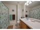 Bright bathroom featuring a shower with floral curtain, sink with cabinet, and neutral tile flooring at 9800 Mayfair St # E, Englewood, CO 80112