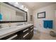 Modern bathroom with a double sink vanity, large mirror, and neutral color scheme at 9800 Mayfair St # E, Englewood, CO 80112
