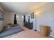Bedroom with carpet, dresser with artwork, a bed with gray blanket, and two bright windows at 9800 Mayfair St # E, Englewood, CO 80112