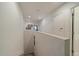 Upstairs hallway with white walls, framed pictures, neutral carpeting and multiple doors at 9800 Mayfair St # E, Englewood, CO 80112