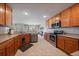 Functional kitchen with wood cabinets, stainless steel appliances, and tile flooring at 9800 Mayfair St # E, Englewood, CO 80112