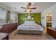 Inviting main bedroom with a bright accent wall, large window, and ceiling fan at 9800 Mayfair St # E, Englewood, CO 80112
