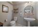 Stylish half-bathroom with modern fixtures, vessel sink, and decorative mirror at 9800 Mayfair St # E, Englewood, CO 80112