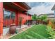 Backyard featuring well-maintained artificial turf, a hot tub, and orange siding at 2868 Kingston St, Denver, CO 80238