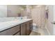 Bright bathroom featuring a modern vanity, white subway tile backsplash, and a shower with a stylish curtain at 2868 Kingston St, Denver, CO 80238