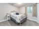 Bedroom with neutral walls, carpet, iron bed frame, and natural light at 2868 Kingston St, Denver, CO 80238