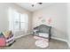 Cozy bedroom with ample natural light, neutral paint, and charming dollhouse at 2868 Kingston St, Denver, CO 80238