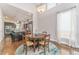 Bright dining room with hardwood floors, area rug, and open kitchen with stainless steel appliances at 2868 Kingston St, Denver, CO 80238