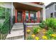 Inviting front porch with seating and well-maintained landscaping leading to the entrance at 2868 Kingston St, Denver, CO 80238