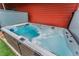 Inviting hot tub with clear blue water, set against a backdrop of wood siding and green turf at 2868 Kingston St, Denver, CO 80238