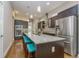 Spacious kitchen with granite countertops, center island, stainless steel appliances and hardwood floors at 2868 Kingston St, Denver, CO 80238