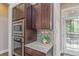 Kitchen area with stainless steel appliances, granite counters, decorative backsplash and backyard view at 2868 Kingston St, Denver, CO 80238