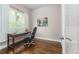 Home office with wooden desk, chair, and hardwood floors and window with nature view at 2868 Kingston St, Denver, CO 80238