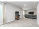 Large carpeted rec room with a classic arcade game and a comfy couch; ideal for entertaining or relaxing at 2868 Kingston St, Denver, CO 80238