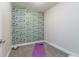 Empty room with patterned wallpaper, carpet flooring, and a yoga mat; perfect for a home gym or meditation space at 2868 Kingston St, Denver, CO 80238