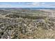 Expansive aerial view showcasing a suburban neighborhood with mountain views and lush green spaces and trees at 53 Taylor Ct, Castle Rock, CO 80104