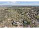 An aerial view captures homes nestled among a rocky and treed terrain in a picturesque neighborhood at 53 Taylor Ct, Castle Rock, CO 80104