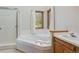 Bright bathroom with a glass shower, soaking tub, and a vanity, featuring wood trim at 53 Taylor Ct, Castle Rock, CO 80104