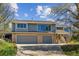 Charming two-story home boasts a brick-accented facade and attached two-car garage, set beneath a bright blue sky at 53 Taylor Ct, Castle Rock, CO 80104