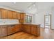 Charming kitchen with wood cabinets, hardwood floors, and modern lighting fixtures at 53 Taylor Ct, Castle Rock, CO 80104