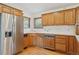 Traditional kitchen with stainless steel refrigerator and wood cabinets on a light hardwood floor at 53 Taylor Ct, Castle Rock, CO 80104