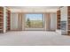 Bright living room featuring built-in shelves, a fireplace, and a large window with scenic views at 53 Taylor Ct, Castle Rock, CO 80104
