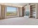 Inviting living room boasting built-in shelves, fireplace and a large window providing a scenic outdoor view at 53 Taylor Ct, Castle Rock, CO 80104