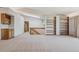 Open-concept living space with staircase, wet bar, and built-in bookcases, offering a versatile layout at 53 Taylor Ct, Castle Rock, CO 80104