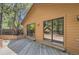 A wooden back deck with sliding glass doors, perfect for outdoor entertaining and relaxation at 7500 E Dartmouth Ave # 22, Denver, CO 80231