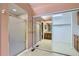A walk-in shower plus a view of the large bathroom with mirrored closets, a shower, and granite countertops at 7500 E Dartmouth Ave # 22, Denver, CO 80231