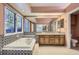 A bathroom featuring an integrated soaking tub, large mirrors and a wood vanity at 7500 E Dartmouth Ave # 22, Denver, CO 80231