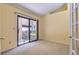 A carpeted room featuring a sliding glass door leading to a deck and french doors at 7500 E Dartmouth Ave # 22, Denver, CO 80231