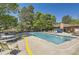A refreshing community pool surrounded by lounge chairs and trees, perfect for summer relaxation at 7500 E Dartmouth Ave # 22, Denver, CO 80231