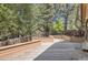 Outdoor deck surrounded by a mature tree line and wood fencing at 7500 E Dartmouth Ave # 22, Denver, CO 80231