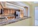 Kitchen featuring wood cabinets, stainless steel fridge, and granite countertops at 7500 E Dartmouth Ave # 22, Denver, CO 80231