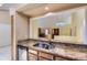 Kitchen with granite counters and stainless-steel appliances, leading to an airy living space at 7500 E Dartmouth Ave # 22, Denver, CO 80231