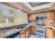 Kitchen boasts wood cabinets, granite countertops, and stainless-steel appliances at 7500 E Dartmouth Ave # 22, Denver, CO 80231