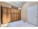 Pantry/hallway features wood cabinets, white tile floors, and an ample storage area at 7500 E Dartmouth Ave # 22, Denver, CO 80231